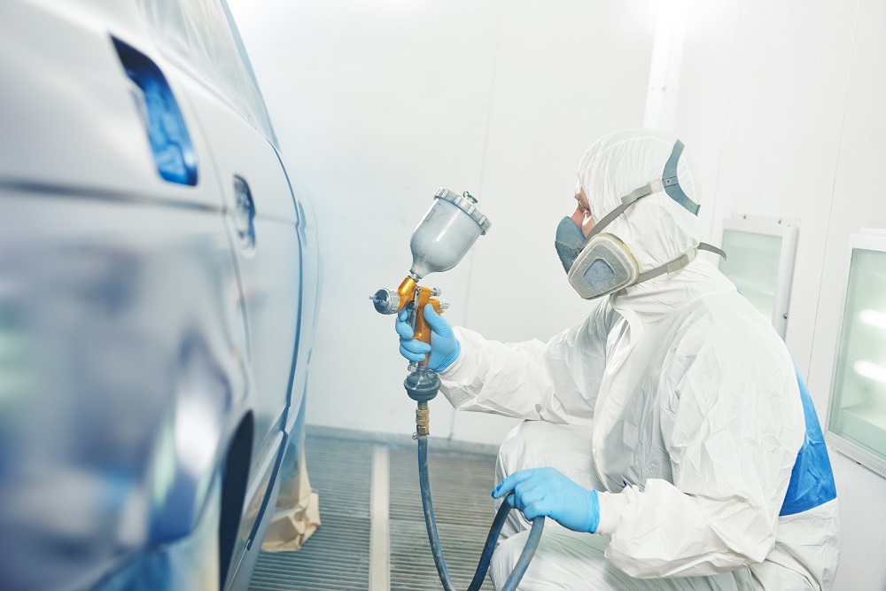 worker painting auto car bumper